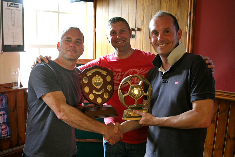 Anthony Woosey collects the trophy from Carl Worsnip and Martin Ellis